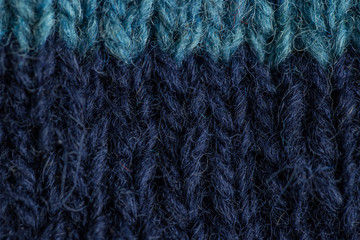 A beautiful closeup of a hand knitted warm and soft wool pattern. Soft socks or scarf of natural wool. Colorful pattern.