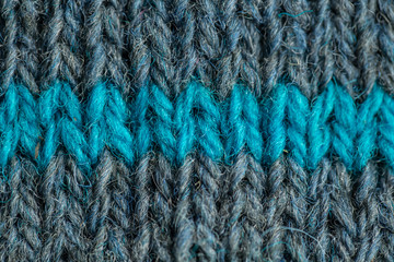 A beautiful closeup of a hand knitted warm and soft wool pattern. Soft socks or scarf of natural wool. Colorful pattern.