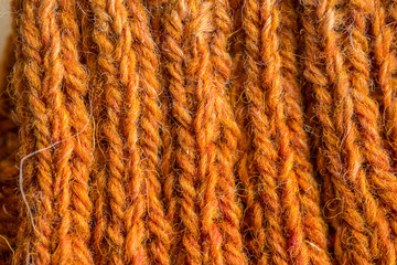 A beautiful closeup of a hand knitted warm and soft wool pattern. Soft socks or scarf of natural wool. Colorful pattern.