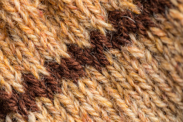 A beautiful closeup of a hand knitted warm and soft wool pattern. Soft socks or scarf of natural wool. Colorful pattern.