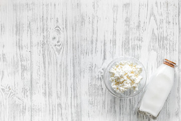 Farm dairy products. Milk and cottage on light wooden background top view copyspace