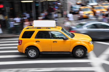 Fototapeta na wymiar Panning shot of a taxicab at Times Square in New York, USA.
