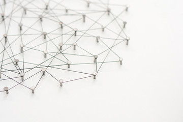 Linking entities. Network, networking, social media, internet communication abstract. A small network connected to a larger network. in paper linked together by cotton with a black tint