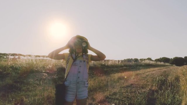 Little Girl Using Binoculars in open field looking around for directions