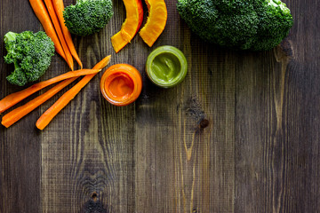 Preparing baby food. Broccoli, pumpkin, apple puree on dark wooden table background top view copyspace