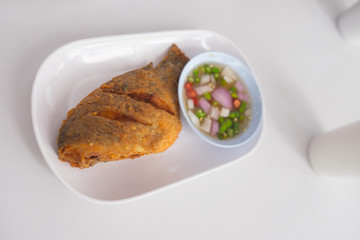 Tilapia fish call Pla Nil Tod in served with spicy Thai sauce.