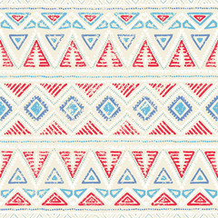 Seamless ethnic pattern. Ornament in tribal style. Grunge texture. Vintage print. Red, white and blue geometric elements.