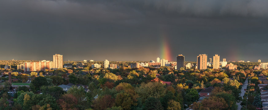 Panorama photo of a partial rainbow during a storm