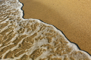 Sand on the beach and sea foam