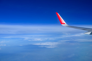Fototapeta na wymiar Wing of a Airplane above clouds