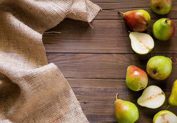 Pears on a wooden background and burlap