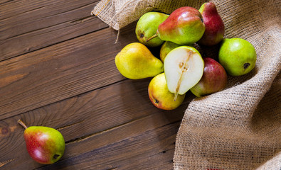 Pears on a wooden background and burlap