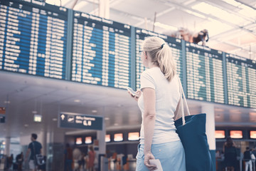 Girl near airline schedule
