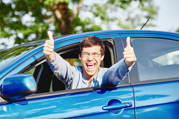 Guy inside car showing thumbs up