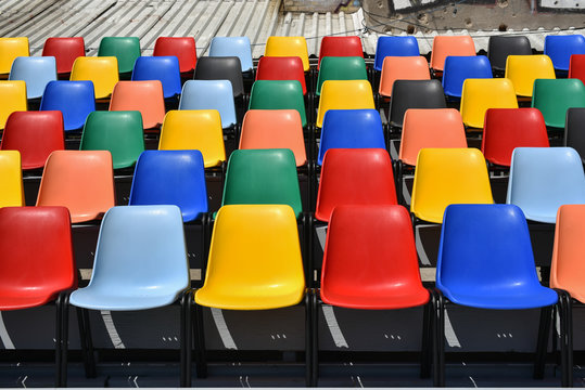 colorful plastic chairs  in rows  horizontal shoot 