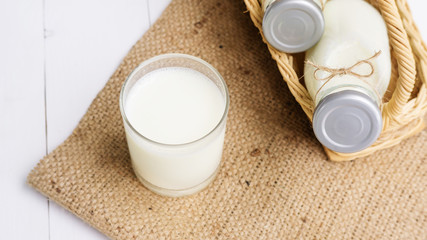 A milk in a glass and a bottle.