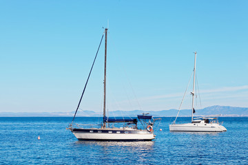 Yatchs moored in the harbor near a small town - Croatia, island Brac