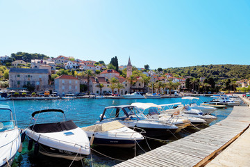 Fototapeta na wymiar Yatchs and boats in the harbor of a small town Splitska - Croatia, island Brac