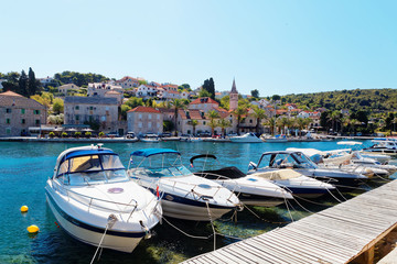 Yatchs and boats moored in the harbor of a small town Splitska - Croatia, island Brac