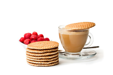 Fototapeta na wymiar Stack of Dutch caramel waffles with fresh raspberry and cup of coffee
