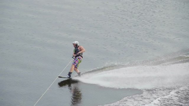 A young man Jumping on the waves the wake behind a boat . Wakeboard. Slow motion. Wake Board. Kaliningrad - July 2017 Russian.