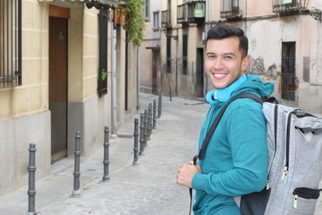 Handsome joyful mixed race person heading to school 