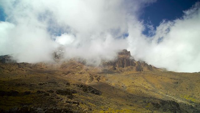 The Summit of Mountain Kilimanjaro is covered by clouds. View from the Barranco Wall camp, Machame route. Africa. Tanzania. Uhuru peak. Track on Kilimanjaro on the Machame Route Whiskey