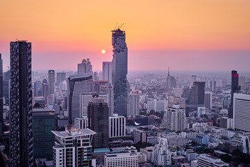 Sunset in megapolis. Beautiful cityscape with top view on skyscrapers. Bangkok, Thailand.