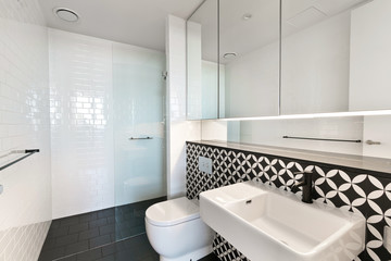 A modern bathroom with a shower area and a bathtub including a wall mirror