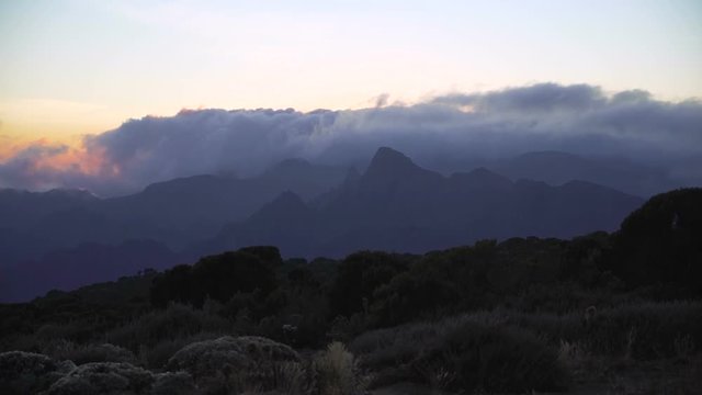 The Summit of Mountain Kilimanjaro is covered by clouds. View from the Barranco Wall camp, Machame route. Africa. Tanzania. Summit of Kilimanjaro. Uhuru peak. Base camp Barranco Wall
