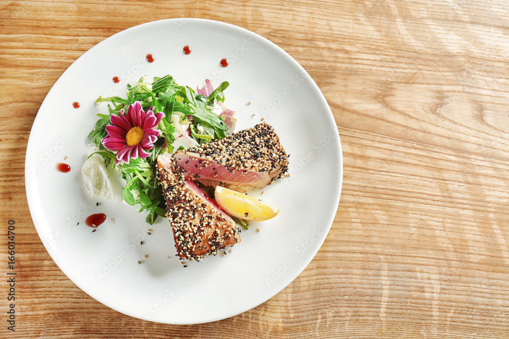 Sticker plate with delicious tuna fillet on table