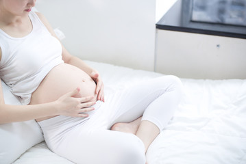 Pregnant woman relaxing at home on the couch