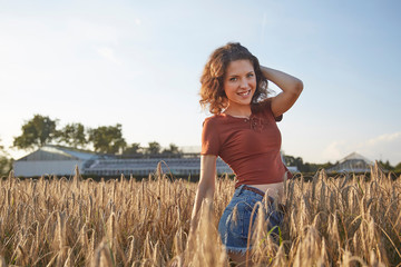 a beautiful woman standing on wheat field