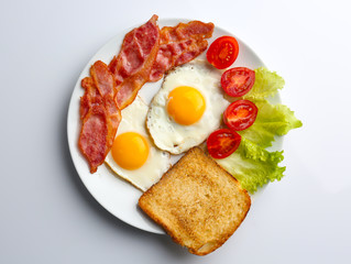 Tasty breakfast with fried eggs on white background