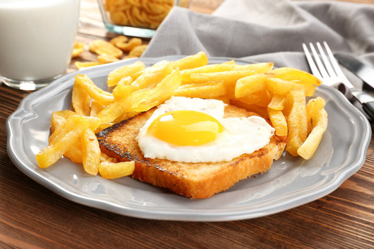 Tasty breakfast with fried egg, closeup