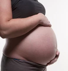 Foto op Canvas pregnant woman with her hands on her belly © Tineke Jongewaard