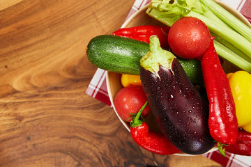 harvest of fresh vegetables and greens on the boards, top view