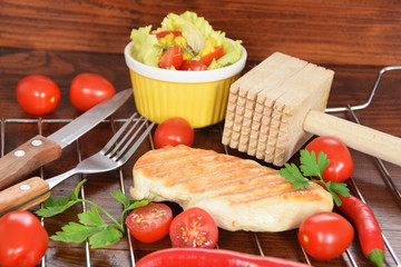 Grilled chicken on a colorful plate with peperoni tomatoes