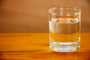 Drinking water in a glass on a wooden table