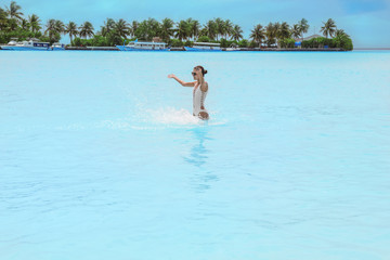 Beautiful young woman bathing at sea resort