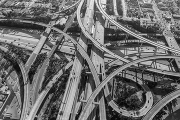 Aerial of the Harbor 110 and Century 105 freeway interchange south of downtown Los Angeles in black...