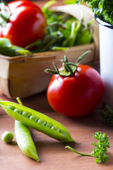 Fresh vegetables Green peas tomatoes dill Wooden background
