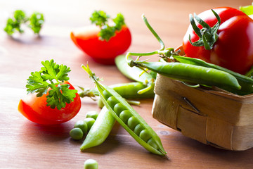 Fresh vegetables Green peas tomatoes dill Wooden background
