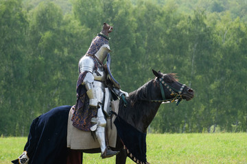 Medieval knight in armor on horseback