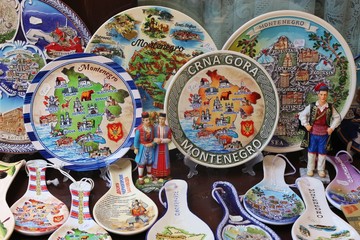 Colorful painted plates and spoons at a souvenir stall in the old city of Bar, Montenegro, Balkan countries, South-Eastern Europe.
