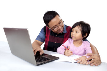 Girl studying with her dad
