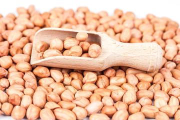 ground nut or peanut with wood spoon on white background.