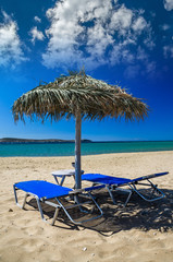 Paros island, Cyclades, Greece. Straw umbrellas and beach loungers on Golden Beach.