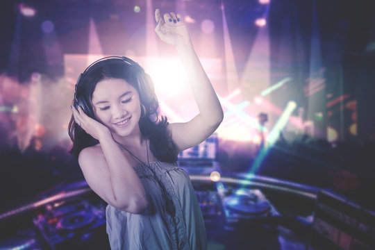 Young DJ dancing in the nightclub
