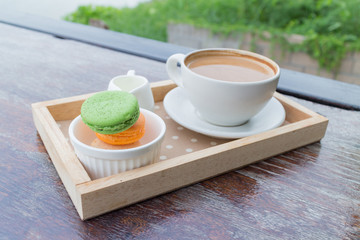 hot coffee breakfast set with fresh macaroon in outdoor bakery house cafe